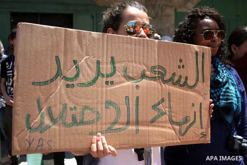 Palestinians and International activists pro-Palestinians demonstrate against the closure of Shuhada Street in Hebron, the main artery blocked by an Israeli military checkpoint in the center of the West Bank town of Hebr...