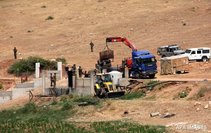 Israeli army machinery destroy a structure built around a Palestinian water well which according to farmers supply and irrigate hundreds of acres of agricultural land on July 12, 2011 in the West Bank village of al-Nassa...