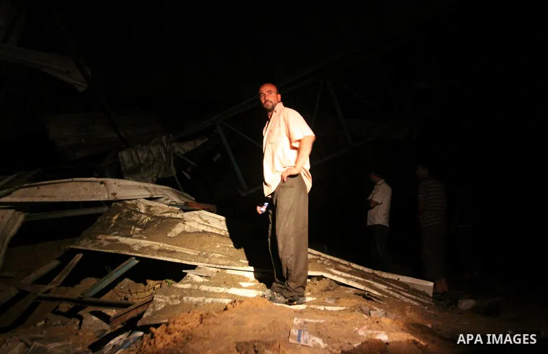 A Palestinian man inspects debris in a destroyed car wash garage after Israeli airstrike in the Al Tuffah area in the east of Gaza City, in the Gaza Strip on 12 July 2011.. Photo by Ali Jadallh