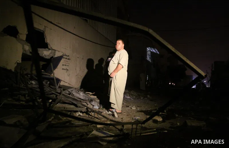 A Palestinian man inspects debris in a destroyed car wash garage after Israeli airstrike in the Al Tuffah area in the east of Gaza City, in the Gaza Strip on 12 July 2011.. Photo by Ali Jadallh