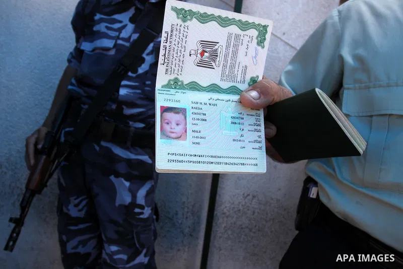 A Palestinian man displays his passport during registration his name with the Ministry of the Interior in the lists of travel in Gaza city on July 13, 2011. Where there are more than 20 thousand citizens need to travel a...