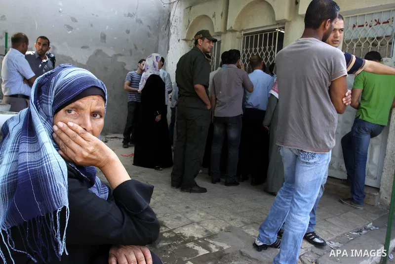 A Palestinian woman waits to register her name with the Ministry of the Interior in the lists of travel in Gaza city on July 13, 2011. Where there are more than 20 thousand citizens need to travel abroad, The Egyptian si...