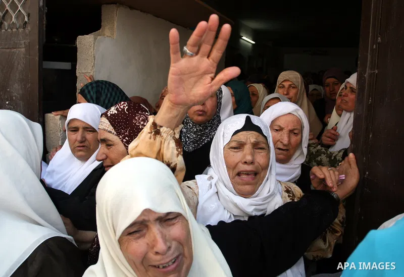 Palestinian women mourn the body of Ibrahim Sarhan, killed by Israeli military, during his funeral in the West Bank refugee camp of El Fara, north of Nablus, Wednesday, July 13, 2011. Sarhan was killed Wednesday in an Is...