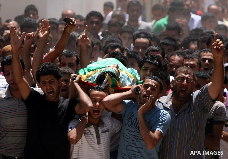 Palestinian mourners carry the body of Ibrahim Sarhan, killed by Israeli military, during his funeral in the West Bank refugee camp of El Fara, north of Nablus, Wednesday, July 13, 2011. Sarhan was killed Wednesday in an...