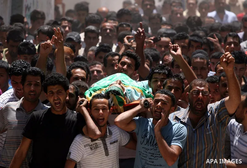 Palestinian mourners carry the body of Ibrahim Sarhan, killed by Israeli military, during his funeral in the West Bank refugee camp of El Fara, north of Nablus, Wednesday, July 13, 2011. Sarhan was killed Wednesday in an...