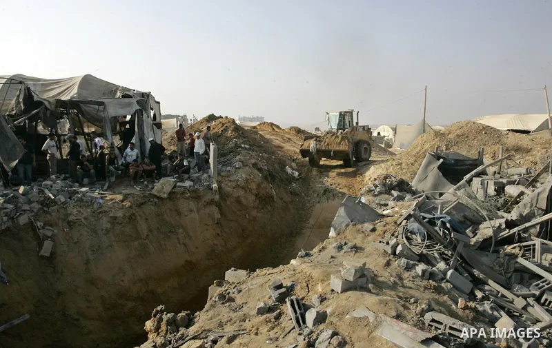 Palestinians inspect the site of a smuggling tunnel between the Gaza Strip and Egypt after it was targeted by an Israeli air strike overnight in Rafah, in the southern enclaved Palestinian territory, on July 14, 2011. Ph...
