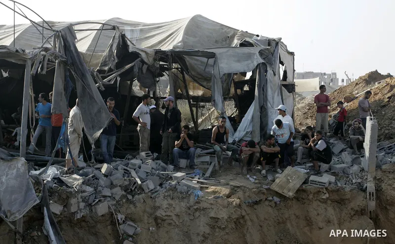 Palestinians inspect the site of a smuggling tunnel between the Gaza Strip and Egypt after it was targeted by an Israeli air strike overnight in Rafah, in the southern enclaved Palestinian territory, on July 14, 2011. Ph...