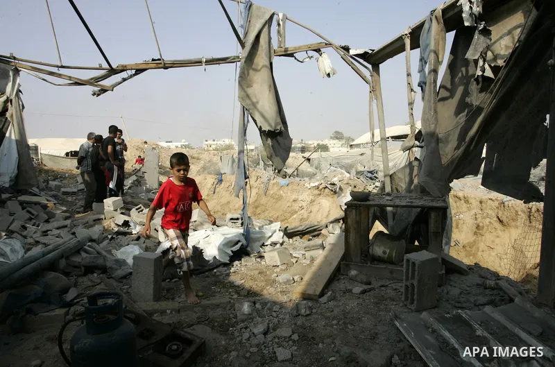 Palestinians inspect the site of a smuggling tunnel between the Gaza Strip and Egypt after it was targeted by an Israeli air strike overnight in Rafah, in the southern enclaved Palestinian territory, on July 14, 2011. Ph...