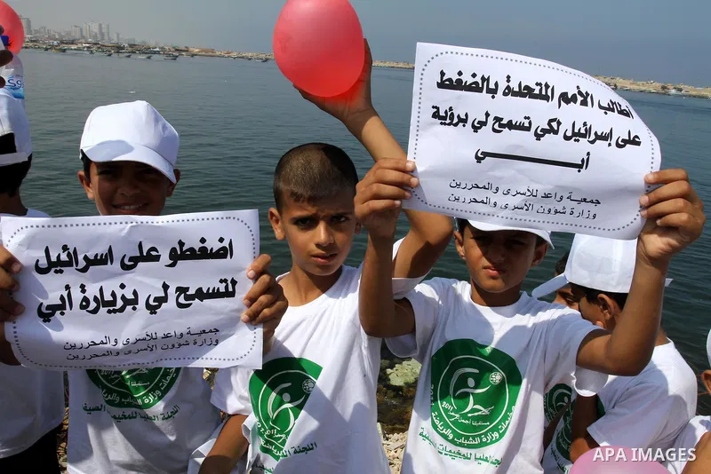 Children of Palestinian prisoners take part in a protest calling Israel to allow residents of Gaza to visit their relatives imprisoned in Israel, on July 14, 2011 in Gaza City. Israel stopped allowing Palestinians from t...