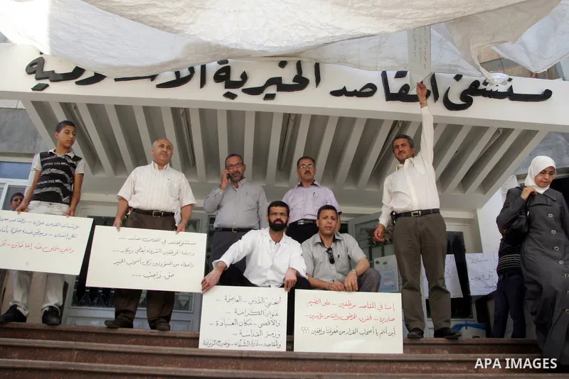 Palestinian staff hold banners in a protest in Al Makassed hospital in Jerusalem on july 14, 2011. Photo by Mahfouz Abu Turk