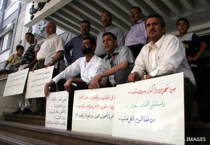 Palestinian staff hold banners in a protest in Al Makassed hospital in Jerusalem on july 14, 2011. Photo by Mahfouz Abu Turk
