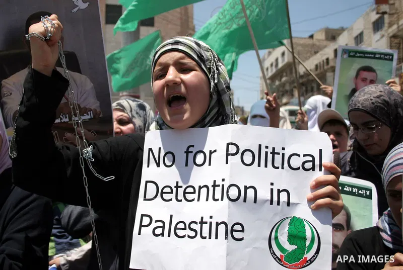 Hamas members of the Palestinian Legislative Council (PLC) take part with Palestinian supporters of the Hamas Islamist movement during a rally calling for the release of Palestinians being held in West Bank and Gaza Stri...