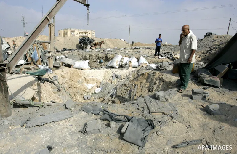 Palestinians inspect damages at a smuggling tunnel between the Gaza Strip and Egypt after it was targeted by an Israeli air strike overnight in the southern town of Rafah on July 15, 2011. Photo by Abed Rahim Khatib