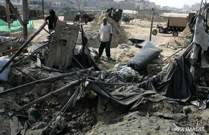 Palestinians inspect damages at a smuggling tunnel between the Gaza Strip and Egypt after it was targeted by an Israeli air strike overnight in the southern town of Rafah on July 15, 2011. Photo by Abed Rahim Khatib