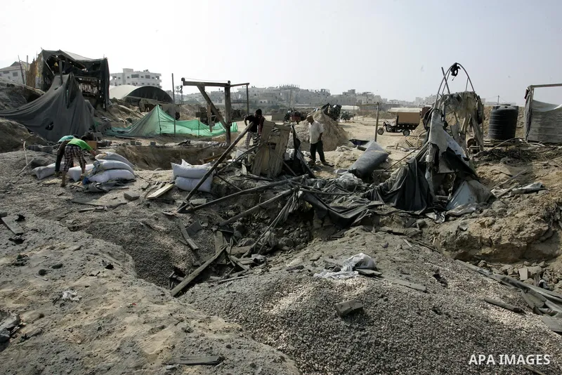 Palestinians inspect damages at a smuggling tunnel between the Gaza Strip and Egypt after it was targeted by an Israeli air strike overnight in the southern town of Rafah on July 15, 2011. Photo by Abed Rahim Khatib