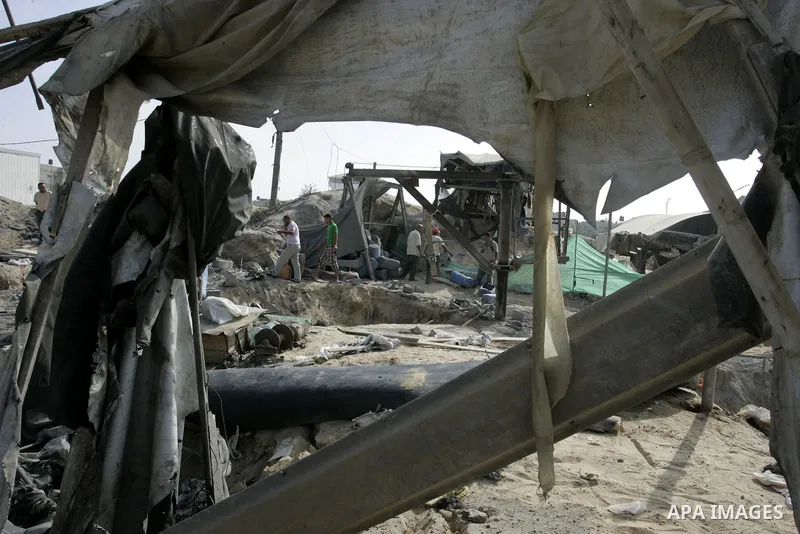 Palestinians inspect damages at a smuggling tunnel between the Gaza Strip and Egypt after it was targeted by an Israeli air strike overnight in the southern town of Rafah on July 15, 2011. Photo by Abed Rahim Khatib