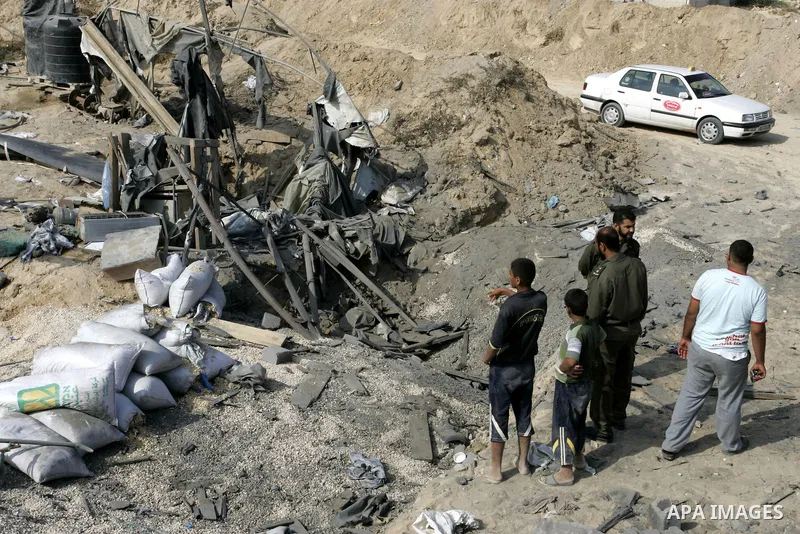 Palestinians inspect damages at a smuggling tunnel between the Gaza Strip and Egypt after it was targeted by an Israeli air strike overnight in the southern town of Rafah on July 15, 2011. Photo by Abed Rahim Khatib
