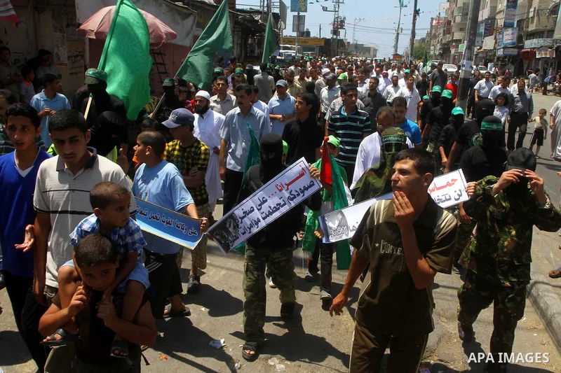 Palestinians Hamas supporters participate in a protest calling for the release of Palestinian prisoners held in Israel and against the UNESCO decision to consider Jerusalem capital of Israel, at the Nusseirat refugee cam...