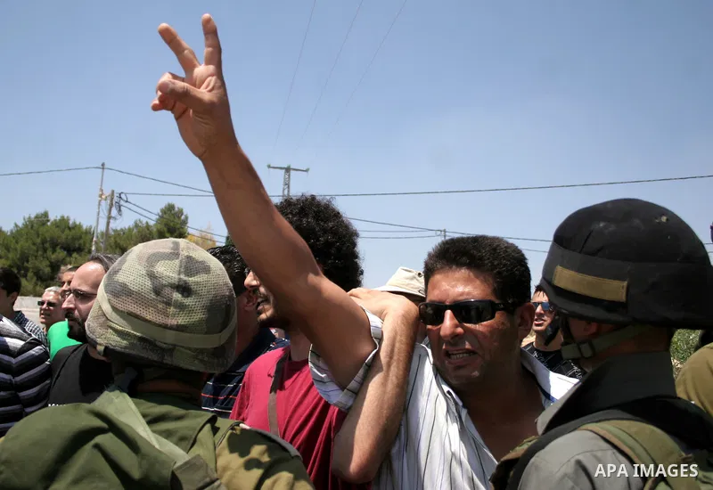 Protesters argue with an Israeli soldiers during a demonstration against Israel's controversial separation barrier in the West Bank village of Maasarah, near the biblical town of Bethlehem on 15 July 2011. Israel says th...