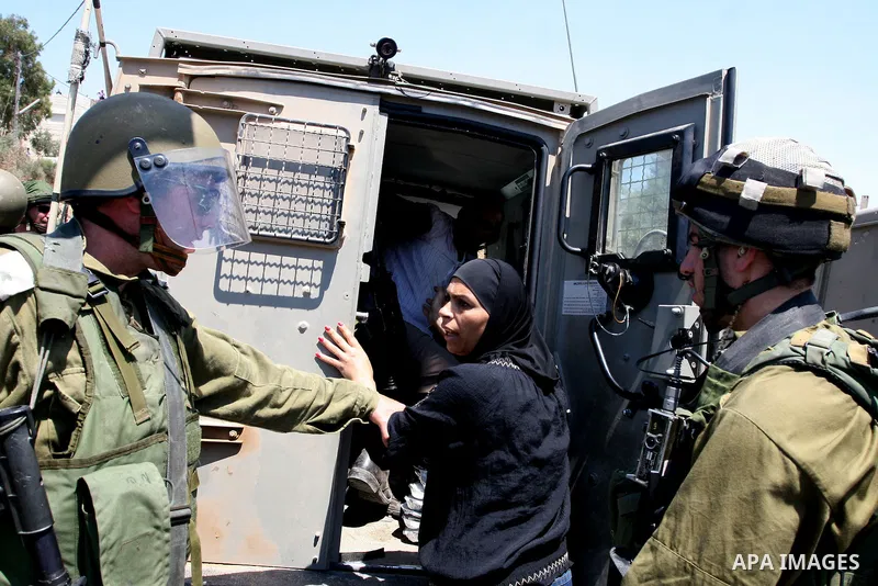 A Palestinian woman argues with an Israeli soldier during clashes with protesters following a demonstration against Israeli occupation and settlements expansion, on July 15, 2011 in the West Bank village of Nabi Saleh Ph...