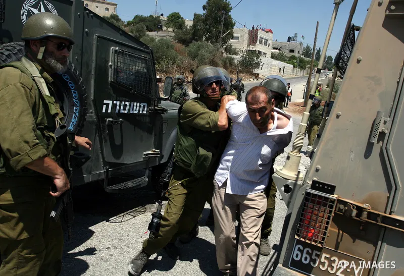 Israeli border guards arrest a Palestinian protestor during clashes following a demonstration against Israeli occupation and settlements expansion, on July 15, 2011 in the West Bank village of Nabi Saleh Photo by Issam R...