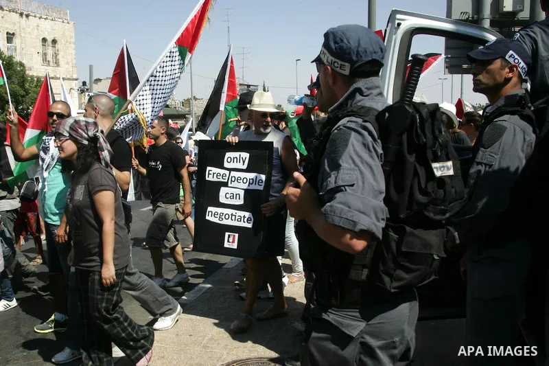 Israeli soldiers stand guards as Israeli, Palestinian and foreign activists march calling for an independent Palestinian state on July 15, 2011. Some 1,000 Israelis and Palestinians gathered in east Jerusalem for a prote...