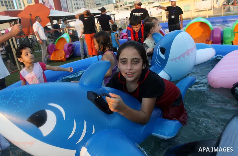 Palestinian children play in a swimming pool at a park in Gaza City on July 15, 2011. Phot by Naaman Omar