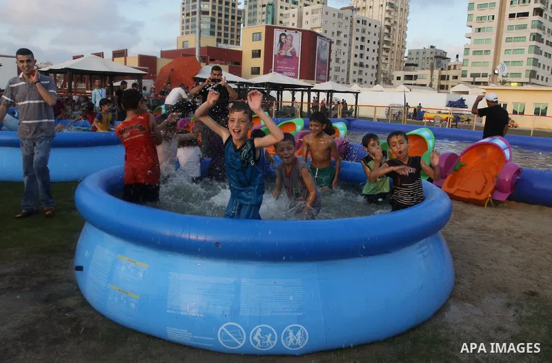 Palestinian children play in a swimming pool at a park in Gaza City on July 15, 2011. Phot by Naaman Omar