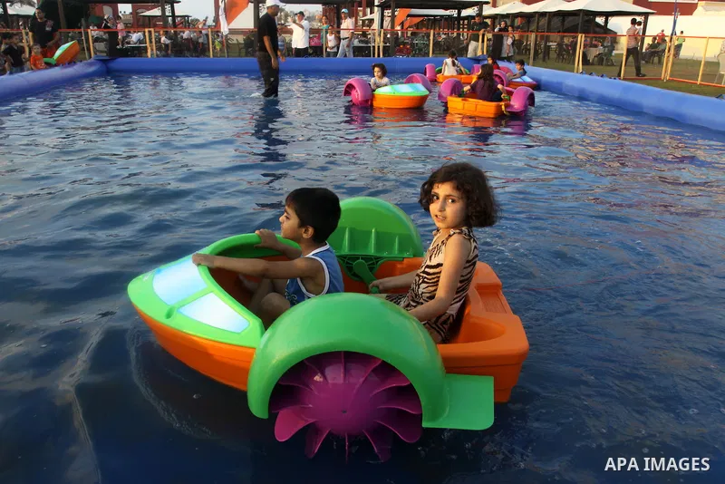 Palestinian children play in a swimming pool at a park in Gaza City on July 15, 2011. Phot by Naaman Omar