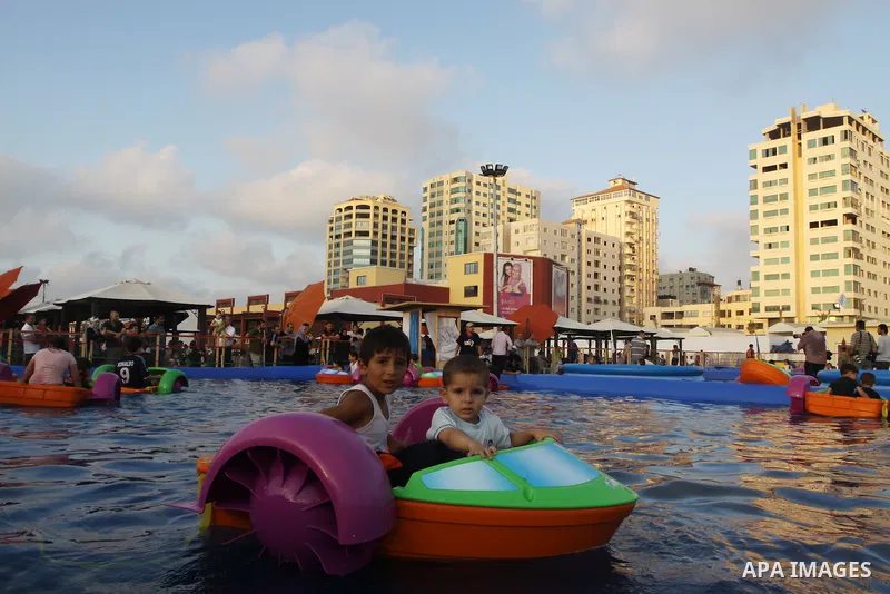 Palestinian children play in a swimming pool at a park in Gaza City on July 15, 2011. Phot by Naaman Omar