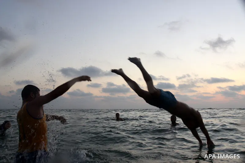 Palestinians enjoy swimming in the sea on Gaza's beach on on July 15, 2011. Reports state that during the summer the beach is a major venue for entertainment and leisure in the Gaza. Photo by Mohammed Asad