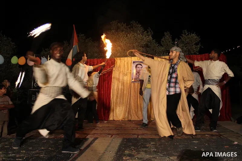 Palestinian youths dance the traditional dabka around the groom during his ceremony in Gaza city on July 16, 2011. Photo by Mohammed Asad
