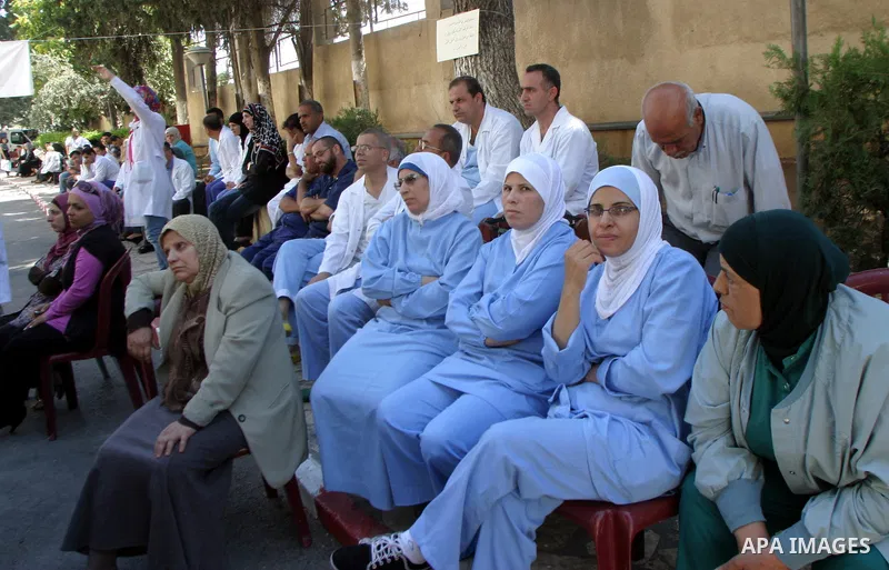 Palestinian staff of Maqasid hospital take part in a protest against the health Ministry calling to pay their dues in Jerusalem on July 18, 2011. Photo by Mahfouz Abu Turk