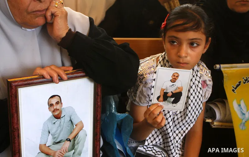 Mothers of Palestinian prisoners held in Israeli jails attend a weekly protest calling for the release of Palestinian prisoners at the International Red Cross building in Gaza City 18 July 2011. It is reported that about...