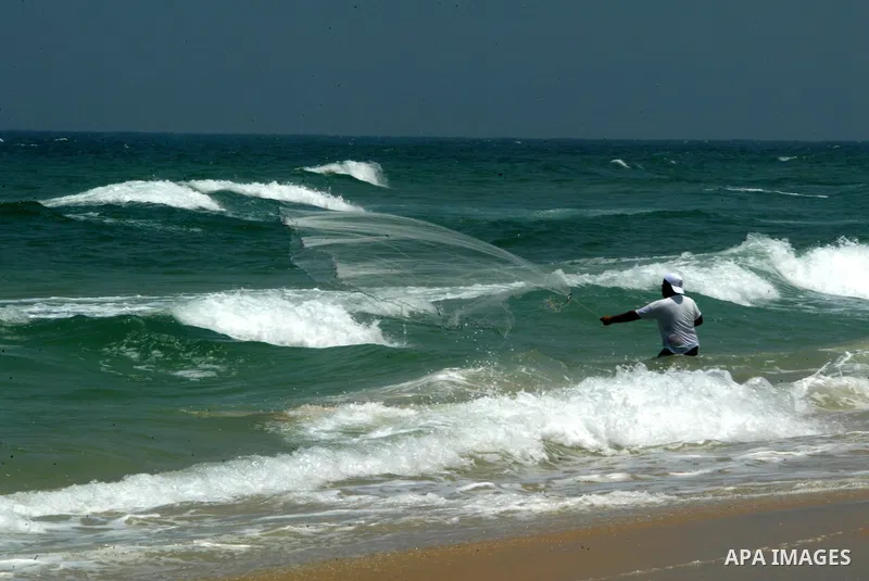 A Palestinian man fishes at Rafah beach in the southern Gaza Strip on July 19, 2011. Israeli naval commandos on Tuesday seized control of a French ship attempting to break Israel's blockade of the Gaza Strip, reporting n...