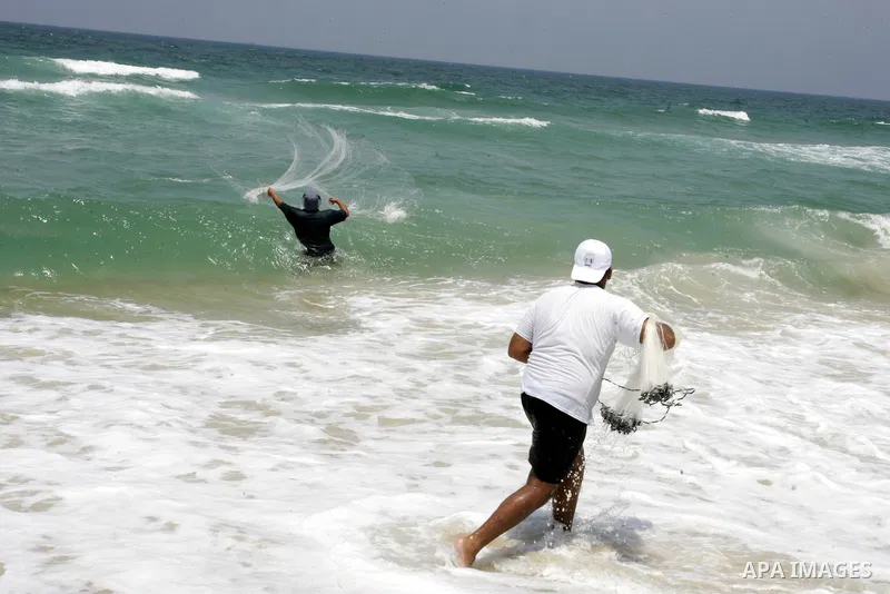 A Palestinian man fishes at Rafah beach in the southern Gaza Strip on July 19, 2011. Israeli naval commandos on Tuesday seized control of a French ship attempting to break Israel's blockade of the Gaza Strip, reporting n...