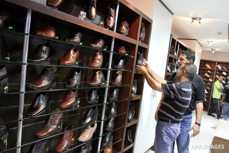 Palestinian shoppers crowd the inside of the shopping mall's new 'Andalusia'. Everything from household goods and food to clothing and shoes are available at the new shopping location in Gaza city on July 19, 2011 . Phot...