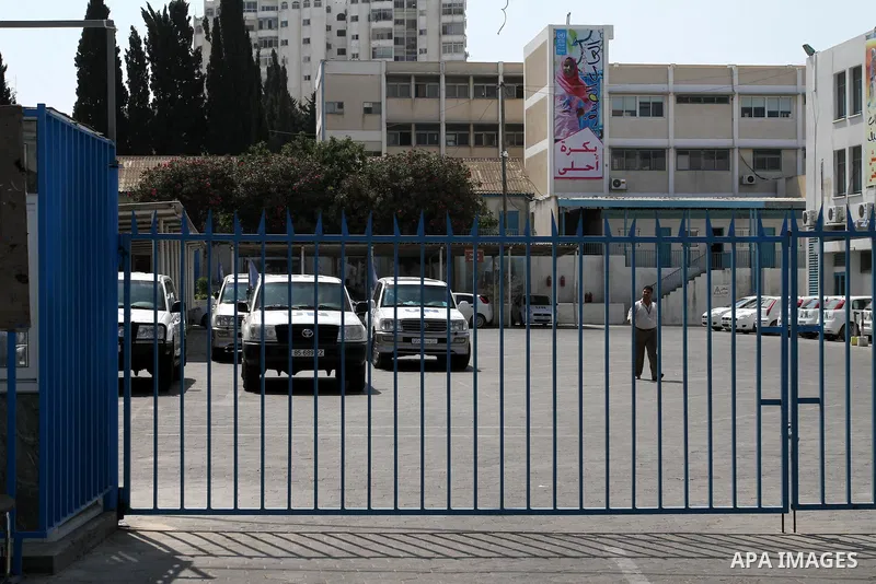 Palestinians close the gates of the UNRWA headquarters in Gaza against the UNRWA decision to change its name in Gaza city on July 20, 2011. Photo by Mohammed Asad
