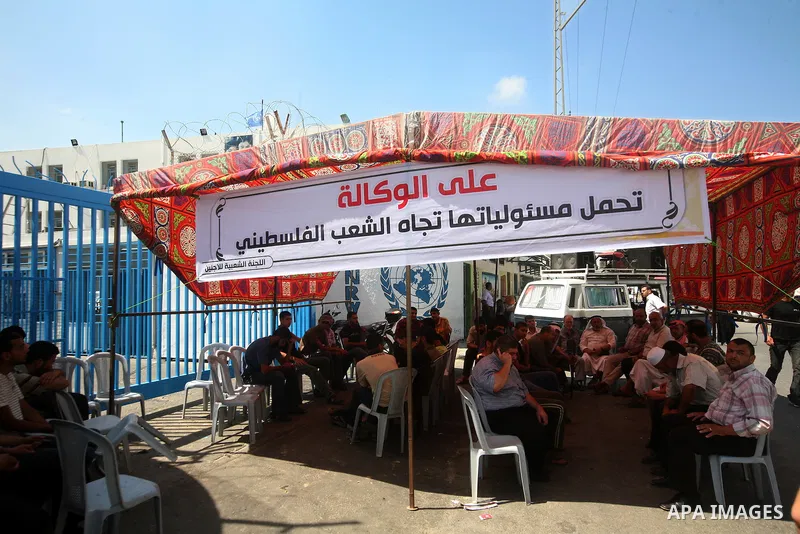 Palestinians take part during a protest infront of the UNRWA headquarters against the UNRWA decision to change its name in Gaza city on July 20, 2011. Photo by Ali Jadallah