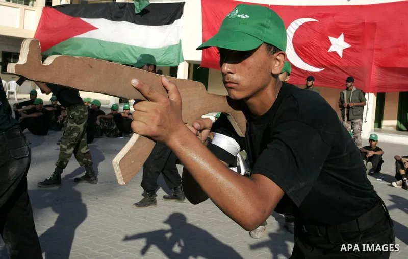 Palestinian youths parade with wooden weapons at a Hamas-run summer camp in Rafah, southern Gaza Strip, on July 20, 2011. The Islamist movement Hamas is holding summer camps throughout the Gaza Strip, where participants...