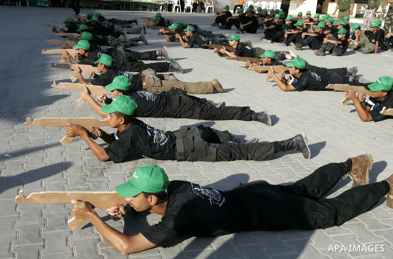 Palestinian youths parade with wooden weapons at a Hamas-run summer camp in Rafah, southern Gaza Strip, on July 20, 2011. The Islamist movement Hamas is holding summer camps throughout the Gaza Strip, where participants...