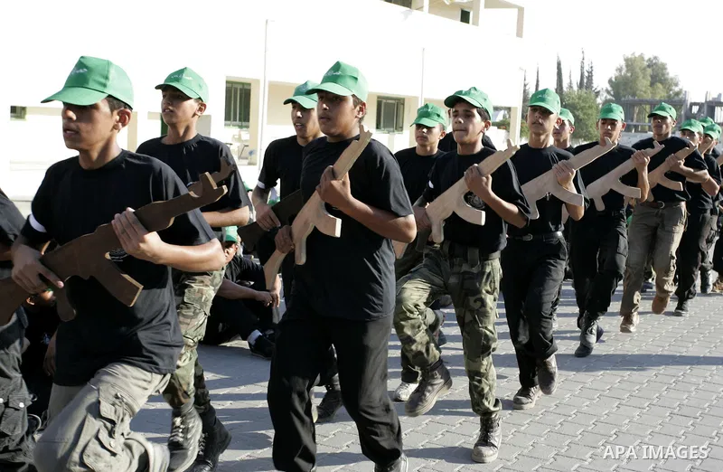 Palestinian youths parade with wooden weapons at a Hamas-run summer camp in Rafah, southern Gaza Strip, on July 20, 2011. The Islamist movement Hamas is holding summer camps throughout the Gaza Strip, where participants...