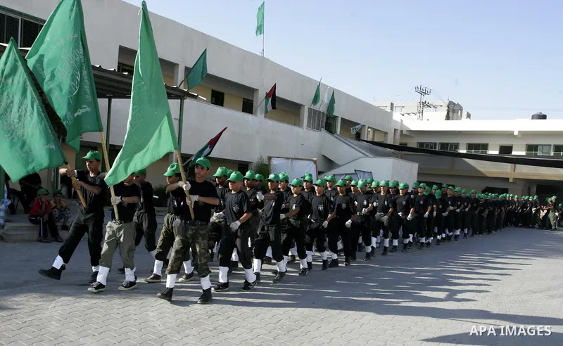 Palestinian youths parade with wooden weapons at a Hamas-run summer camp in Rafah, southern Gaza Strip, on July 20, 2011. The Islamist movement Hamas is holding summer camps throughout the Gaza Strip, where participants...