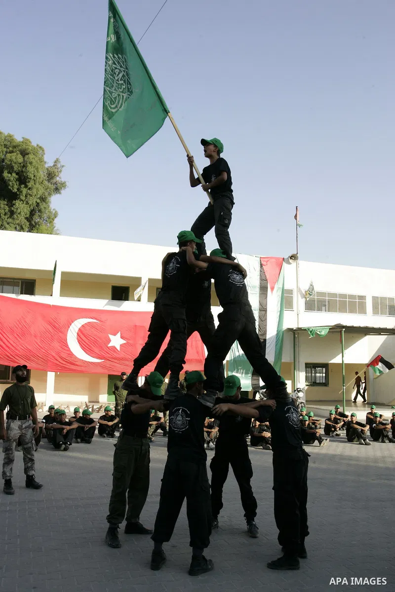 Palestinian youths parade with wooden weapons at a Hamas-run summer camp in Rafah, southern Gaza Strip, on July 20, 2011. The Islamist movement Hamas is holding summer camps throughout the Gaza Strip, where participants...