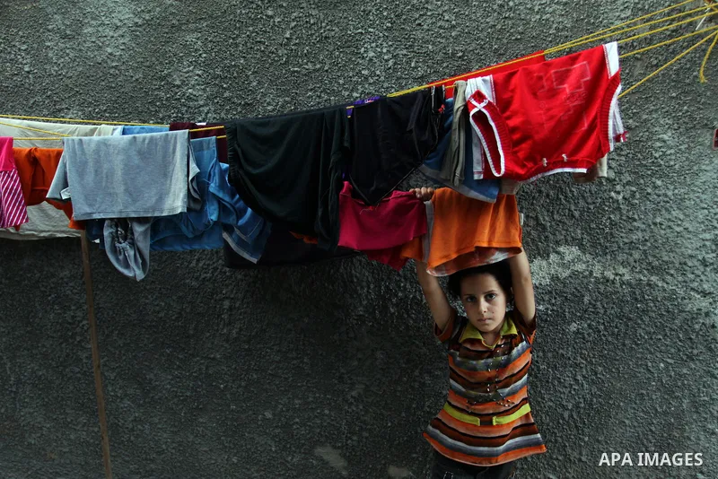 A Palestinian girl plays in front of her house in Jabaliya refugee camp in the northern area of the Gaza Strip on July 21, 2011. The UN Relief and Works Agency (UNRWA) will reduce some of its services for Palestinian ref...