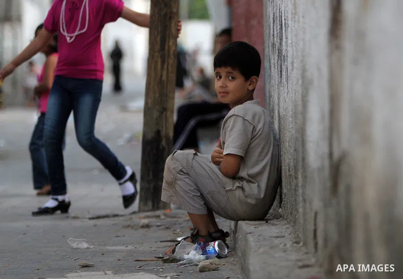 A Palestinian boy sits in front of her house in Jabaliya refugee camp in the northern area of the Gaza Strip on July 21, 2011. The UN Relief and Works Agency (UNRWA) will reduce some of its services for Palestinian refug...