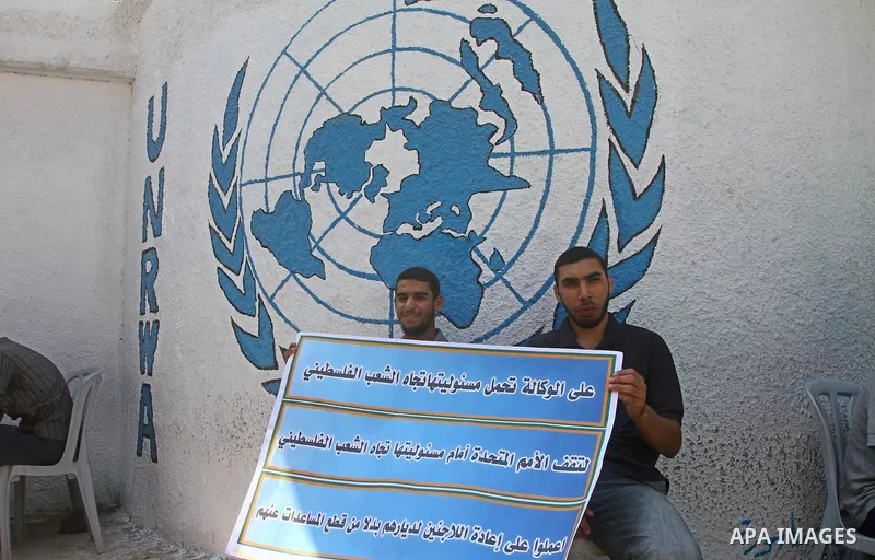 Palestinians take part during a protest infront of the UNRWA headquarters against the UNRWA decision to change its name and Reduce aid in Gaza city on July 21, 2011. Photo by Ashraf Amra