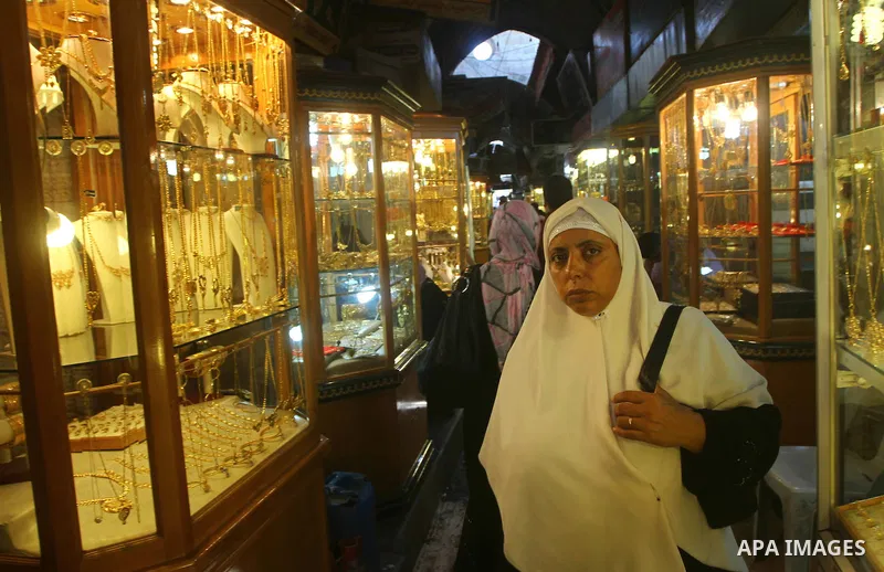 A Palestinian woman looks at gold jewellery at a jewellery store in Gaza city on 21 July 2011. A Palestinian vendor says that the one gold ounce cost 1650 US dollars at the local market which is and all time high for the...