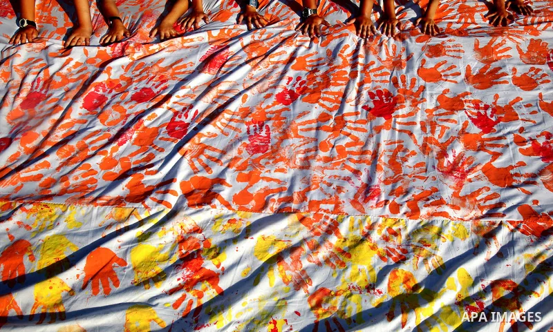 Palestinian children attend an event organised by the the United Nations Relief and Works Agency (UNRWA) in which they attempt to break the Guinness world record for the largest hand-print paint in Khan Yunis, southern G...