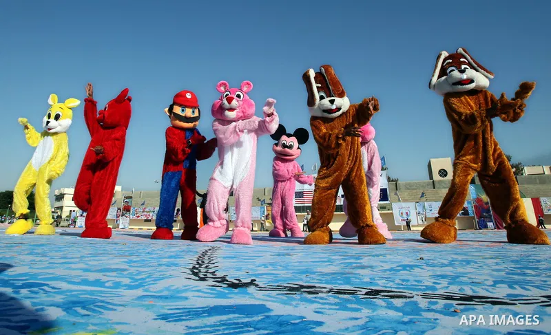 Palestinian children attend an event organised by the the United Nations Relief and Works Agency (UNRWA) in which they attempt to break the Guinness world record for the largest hand-print paint in Khan Yunis, southern G...
